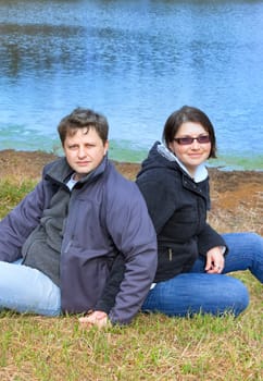 Young caucasian couple enjoying a spring day together by the lake.