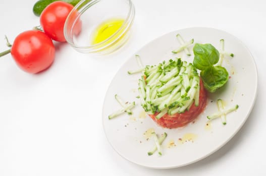 Tomatoes, olive oil and salad on the plate