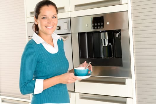 Smiling woman drinking cappuccino kitchen machine cup home interior
