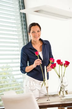 Happy woman putting bouquet dinner table romantic