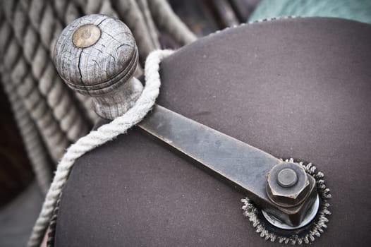 The handle of a drum for winding a rope,  on an ancient sailing vessel