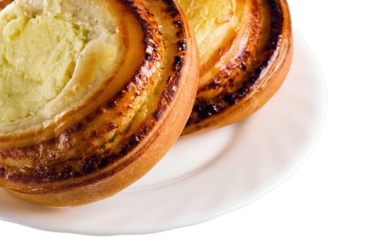 Fresh bread rolls with cheese on a saucer is isolated on white