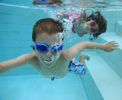 Boy and girl swimming underwater