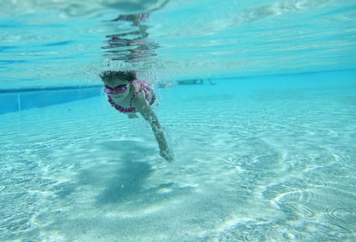 Underwater shot of little girl swimming