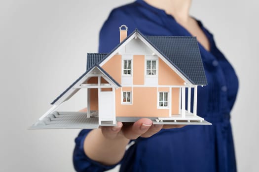 Real estate agent offer house represented by model.