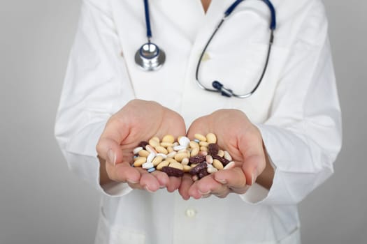 Doctor with a handful of drugs.