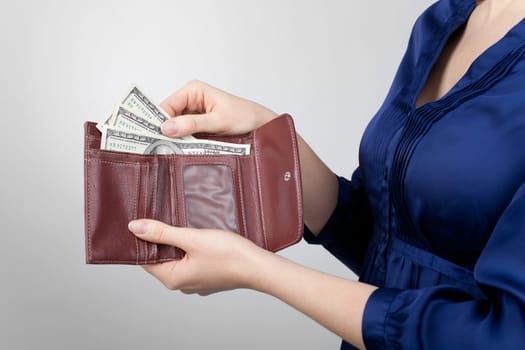 Woman take dollar money out from wallet.