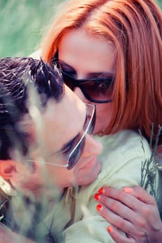 Young caucasian couple enjoying a spring day outdoors and kissing.