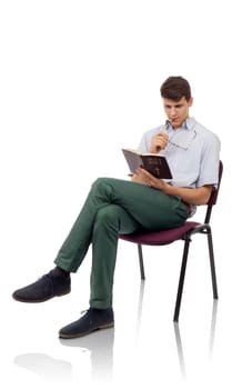 Young christian man sitting and reading Holy Bible