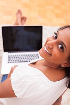 Young beautiful indian woman using a laptop