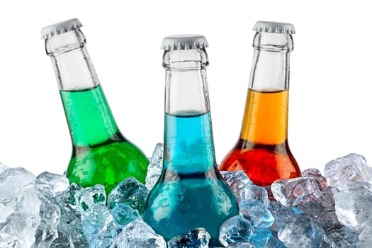 Three bottles of soft drinks in crushed ice.