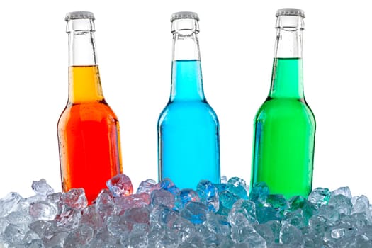 Three bottles of soft drinks in crushed ice.