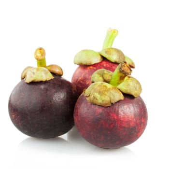 Three mangosteen isolated on a white background