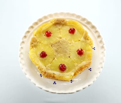 Fresh baked pineapple upside down cake with glace cherries.