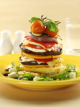 Assorted vegetables including cherry tomato, eggplant, onion and pumpkin stacked on turkish bread.