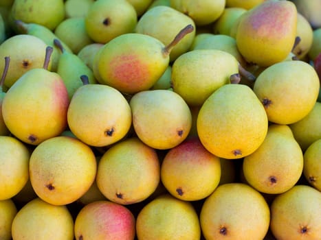 pears fruits stacked in a row on market display