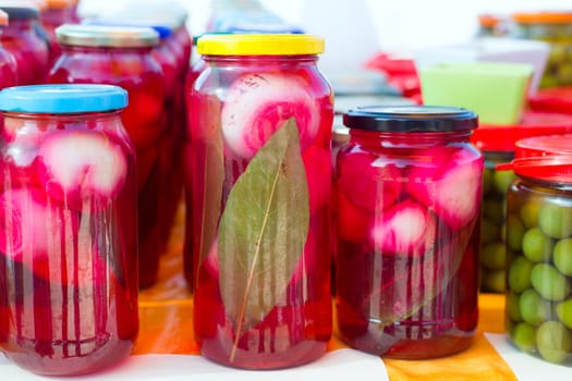mediterranean pickled onions in red vinegar glass pots traditional tinned food