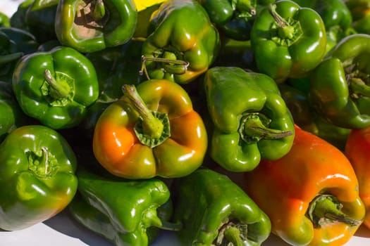 green peppers stacked in a row at market vegetables food