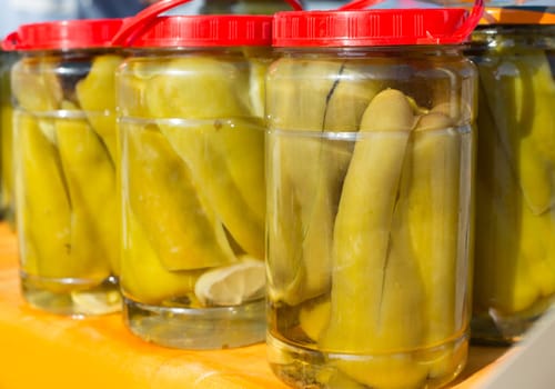 mediterranean pickled green pepper in vinegar glass pots traditional tinned food