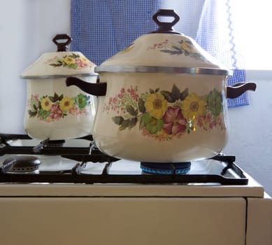 Retro vintage kitchen with pots pans with porcelain flowers
