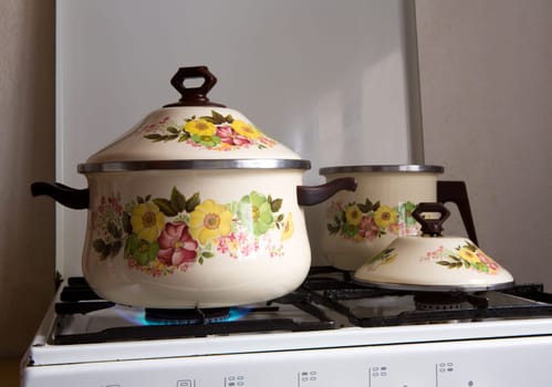 Retro vintage kitchen with pots pans with porcelain flowers