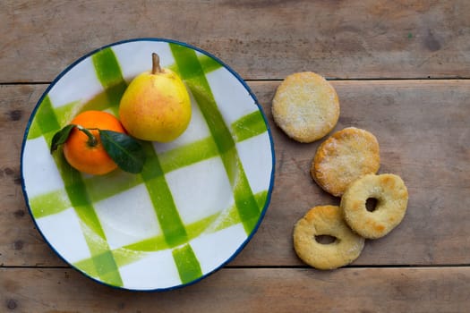 fruits tangerine and pear in vintage porcelain dish with handmade biscuits