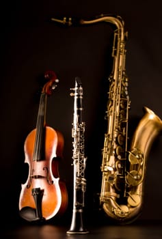 Music Sax tenor saxophone violin and clarinet in black background