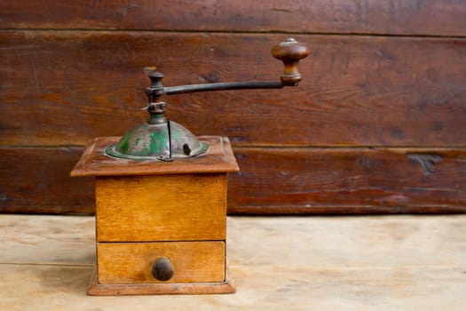 retro old coffee grinder with vintage wooden background