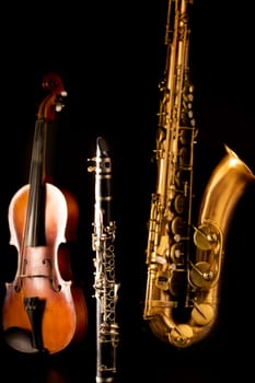 Music Sax tenor saxophone violin and clarinet in black background