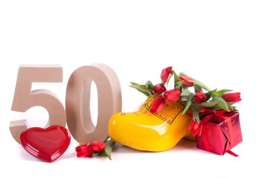 Number of age in a colorful studio setting and Dutch looking attributes like a clog woonden shoe and tulips