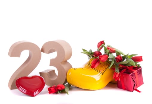 Number of age in a colorful studio setting and Dutch looking attributes like a clog woonden shoe and tulips