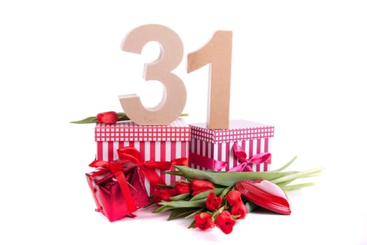 Number of age in a colorful studio setting with a red heart and gifts and tulips
