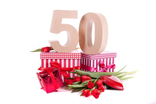 Number of age in a colorful studio setting with a red heart and gifts and tulips