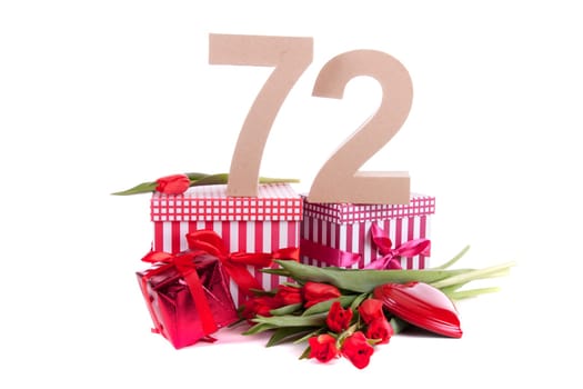 Number of age in a colorful studio setting with a red heart and gifts and tulips