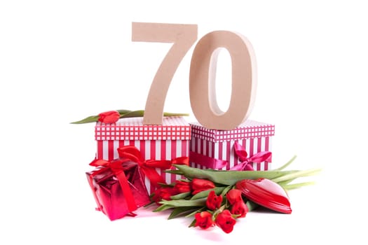 Number of age in a colorful studio setting with a red heart and gifts and tulips