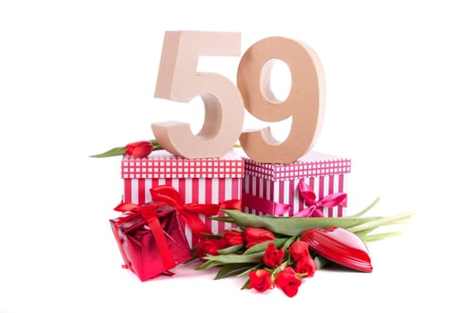 Number of age in a colorful studio setting with a red heart and gifts and tulips
