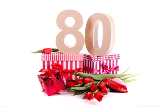 Number of age in a colorful studio setting with a red heart and gifts and tulips