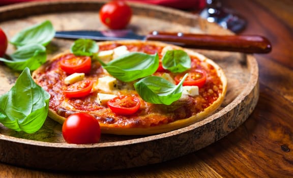 Pizza with mozzarella, salami and basil