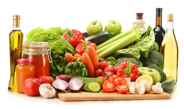 Composition with raw vegetables in wicker basket isolated on white