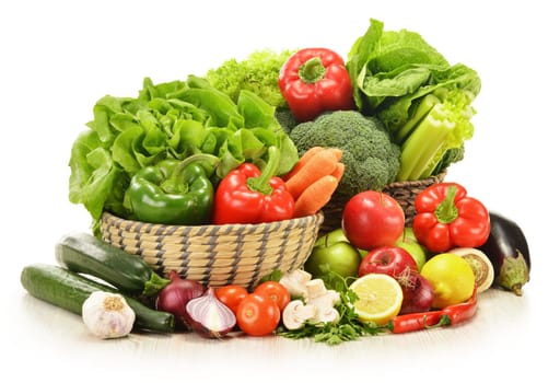 Composition with raw vegetables in wicker basket isolated on white