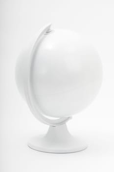 All white world globe on a stand shot in studio