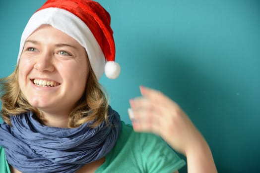 Joking young woman with it Christmas hat