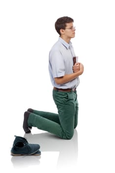 Young man humble knelt for prayer with the Bible in hands and a pair of shoes behind. (Concept for humble prayer time or holy place in my life.)