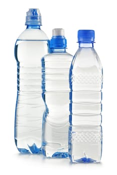Composition with polycarbonate plastic bottles of mineral water isolated on white background