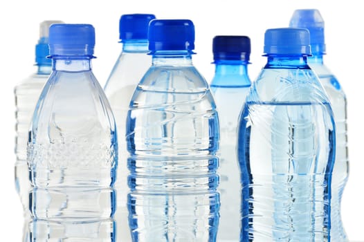 Composition with polycarbonate plastic bottles of mineral water isolated on white background