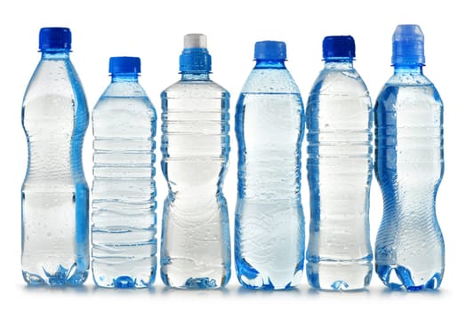 Composition with polycarbonate plastic bottles of mineral water isolated on white background