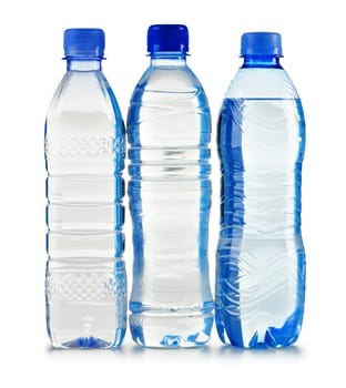 Composition with polycarbonate plastic bottles of mineral water isolated on white background