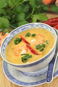 Curry soup with colourful vegetables and prawns