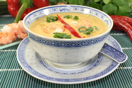 Curry soup with colourful vegetables and prawns