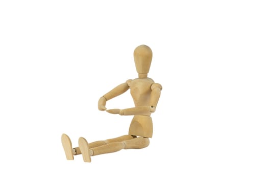 A wooden female doll sitting and looking on her palms